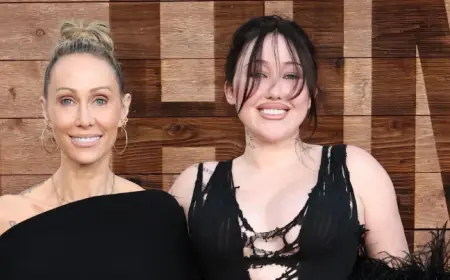 Noah Cyrus and Tish Cyrus step back together onto a red carpet