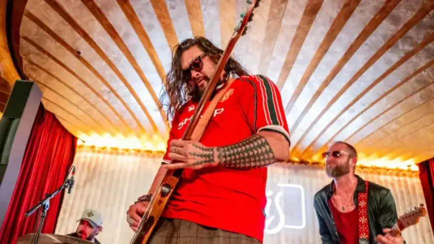 Jason Momoa Joins Adria Arjona Onstage in Surprise Band Performance